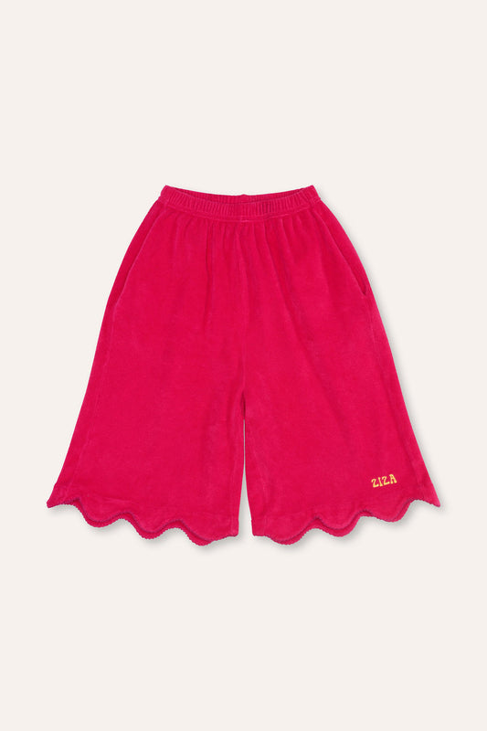 Kid wearing the ZIZA CLUB Bermuda WAVES Bubble, pink kids bermuda shorts with wavy edges